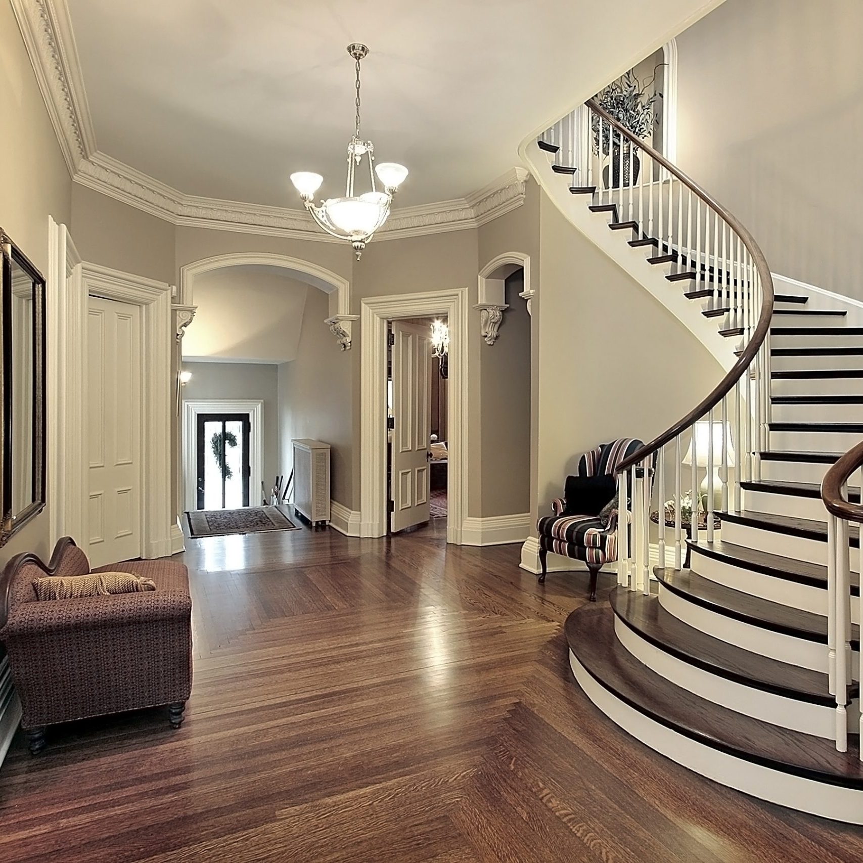 Foyer in traditional suburban home with curved staircase